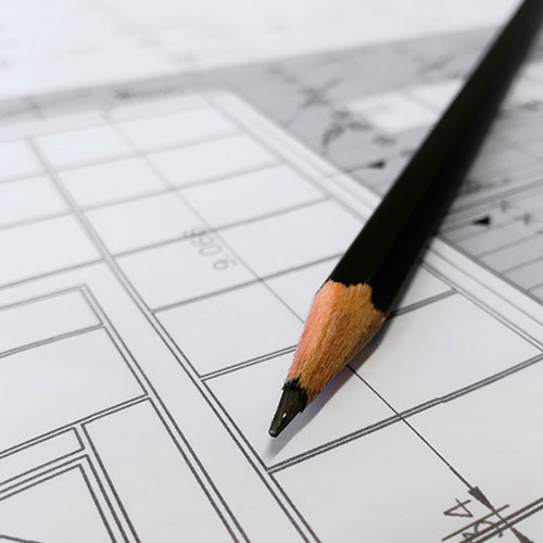 close up of a pencil on blueprints